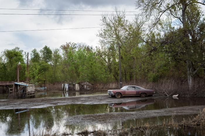 Old Red Car in Flooded Yard, Braithwaite, Louisiana by Carolyn Monastra